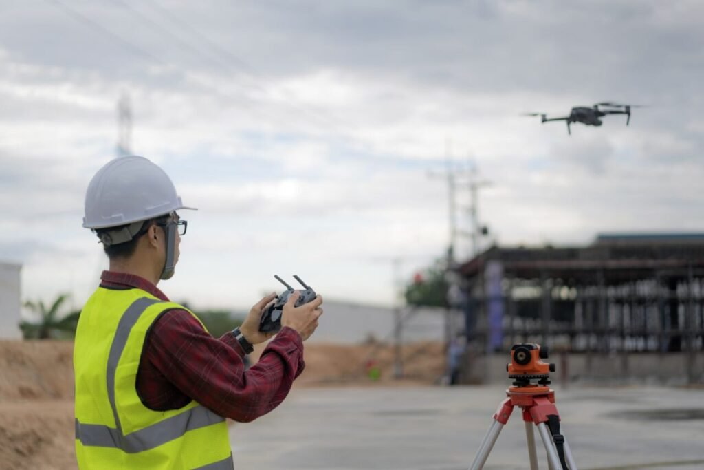 Asian Construction worker using drone at building site